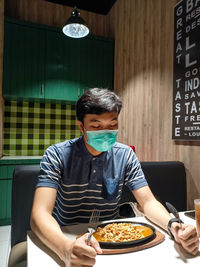 Young man sitting in restaurant