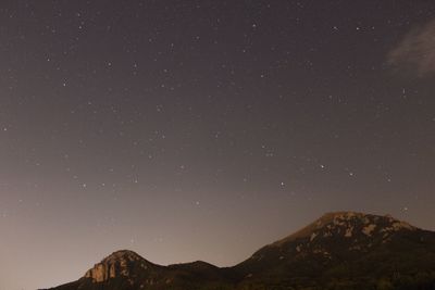 Low angle view of mountain against sky at night