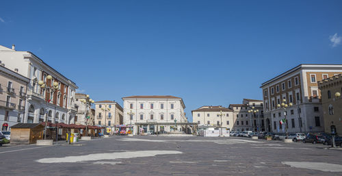 Extra wide angle view of the beautiful piazza duomo in l'aquila with historic buildings and churches
