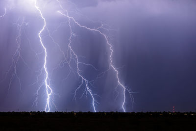 Lightning bolts strike from a powerful monsoon storm over queen creek, arizona.
