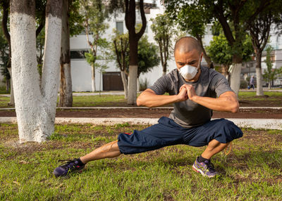 Full length of man exercising in park