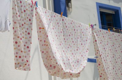 Midsection of women hanging on clothesline