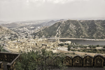 Aerial view of buildings and mountains against sky