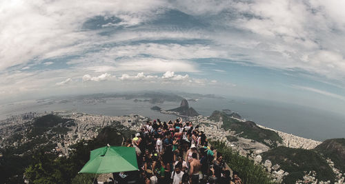 People on mountain against sky