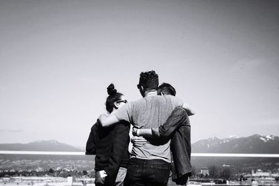 Rear view of couple against mountains against clear sky