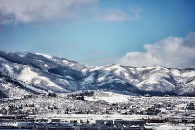 Town by mountains against sky