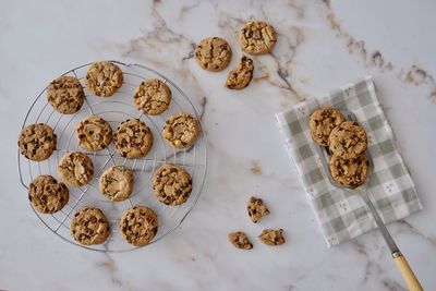 Directly above shot of chocolate chip cookies on marble table. 