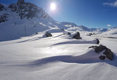 Scenic view of snow covered mountains against sky