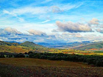 Scenic view of landscape against cloudy sky