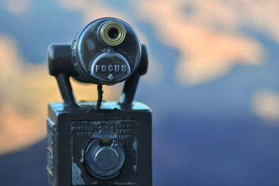 Close-up of coin-operated binoculars against camera