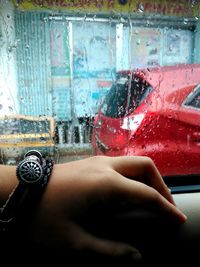 Close-up of hand on car window