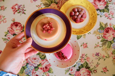 High angle view of hand holding tea cup on table