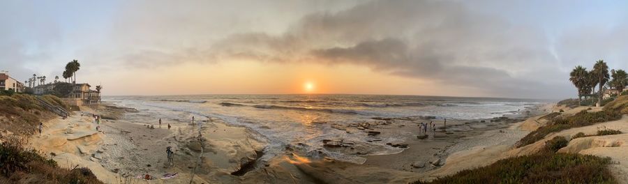 Scenic view of beach against sky during sunset