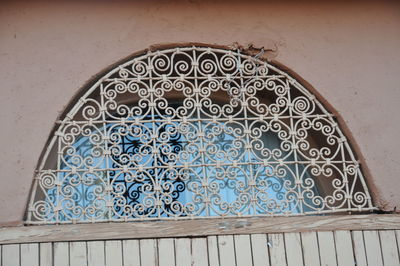 Low angle view of window on tiled wall of building