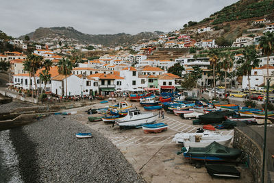 Aerial view of townscape and harbor against sky