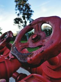 Close-up of rusty wheel against sky