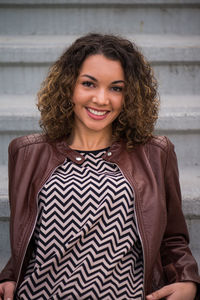 Portrait of beautiful woman sitting on steps