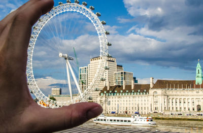 Cropped image of person against sky in city