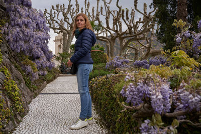 Portrait of young woman walking on field