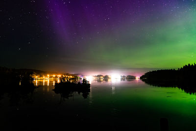 Scenic view of lake against sky at night