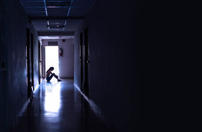 Man walking in corridor of building