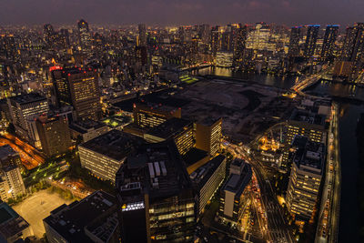 High angle view of illuminated city buildings at night