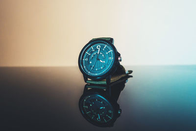 Close-up of clock on table against sea