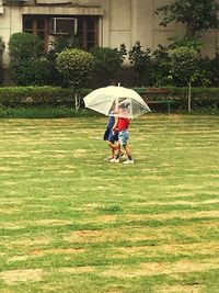 Full length of girl standing on grassy field