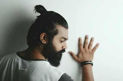 Bearded young man against white background