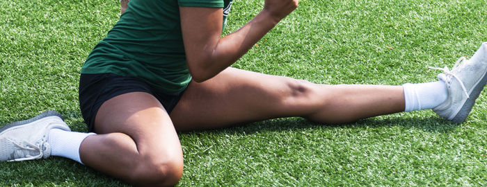 Low section of man lying on field