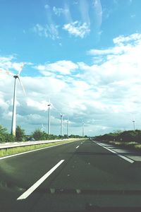 Empty road against cloudy sky