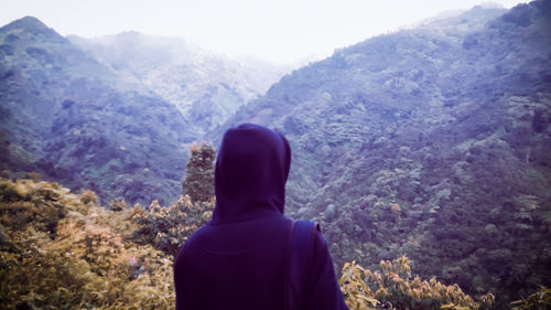 Rear view of man looking at mountains