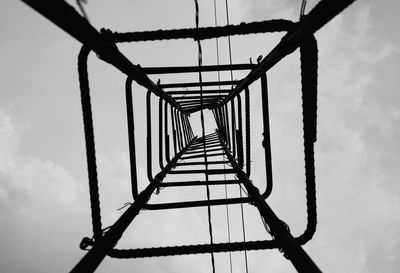 Low angle view of metallic tower against sky