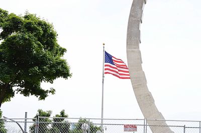 Low angle view of american flag against sky