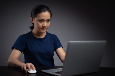 Portrait of teenage girl sitting on table