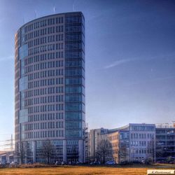 Low angle view of modern building against blue sky