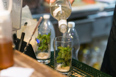 Cropped image of person preparing drink