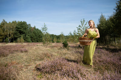 Portrait of woman standing on field