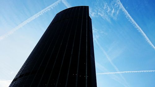 Low angle view of modern building against blue sky