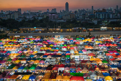 High angle view of illuminated market stalls and city