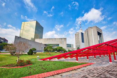 View of modern buildings against cloudy sky