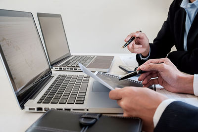 Low angle view of man using mobile phone on table