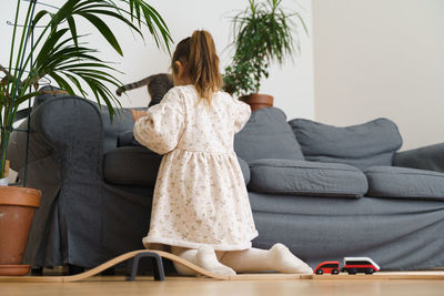 Young woman sitting on sofa at home