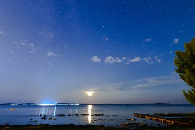 Scenic view of sea against sky at night