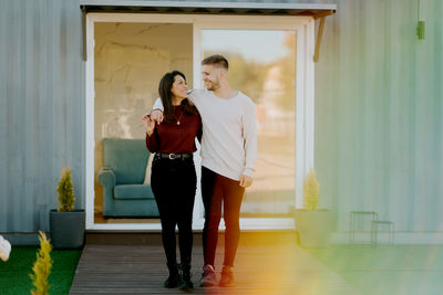 Full length of couple standing in corridor