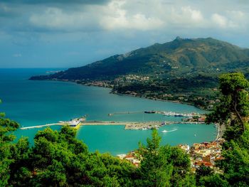 Scenic view of sea and mountains against sky