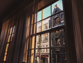 Low angle view of buildings in city seen from window