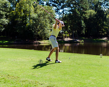 Young man playing golf at park