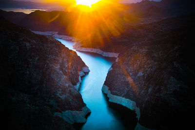 Bright sunset over a river in a canyon