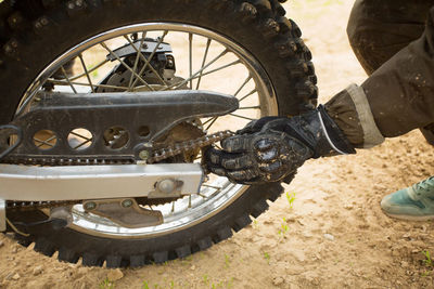 Low section of person checking the motorcycle